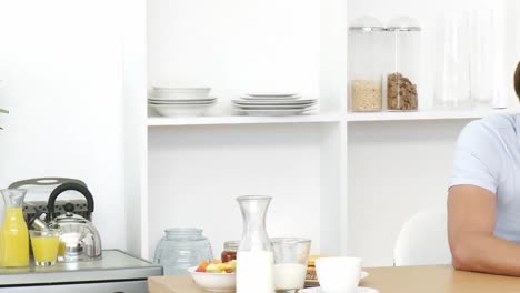 panorama of man reading a newspaper in the kitchen