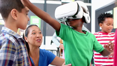 in school, children using vr headset with teacher guiding them in classroom