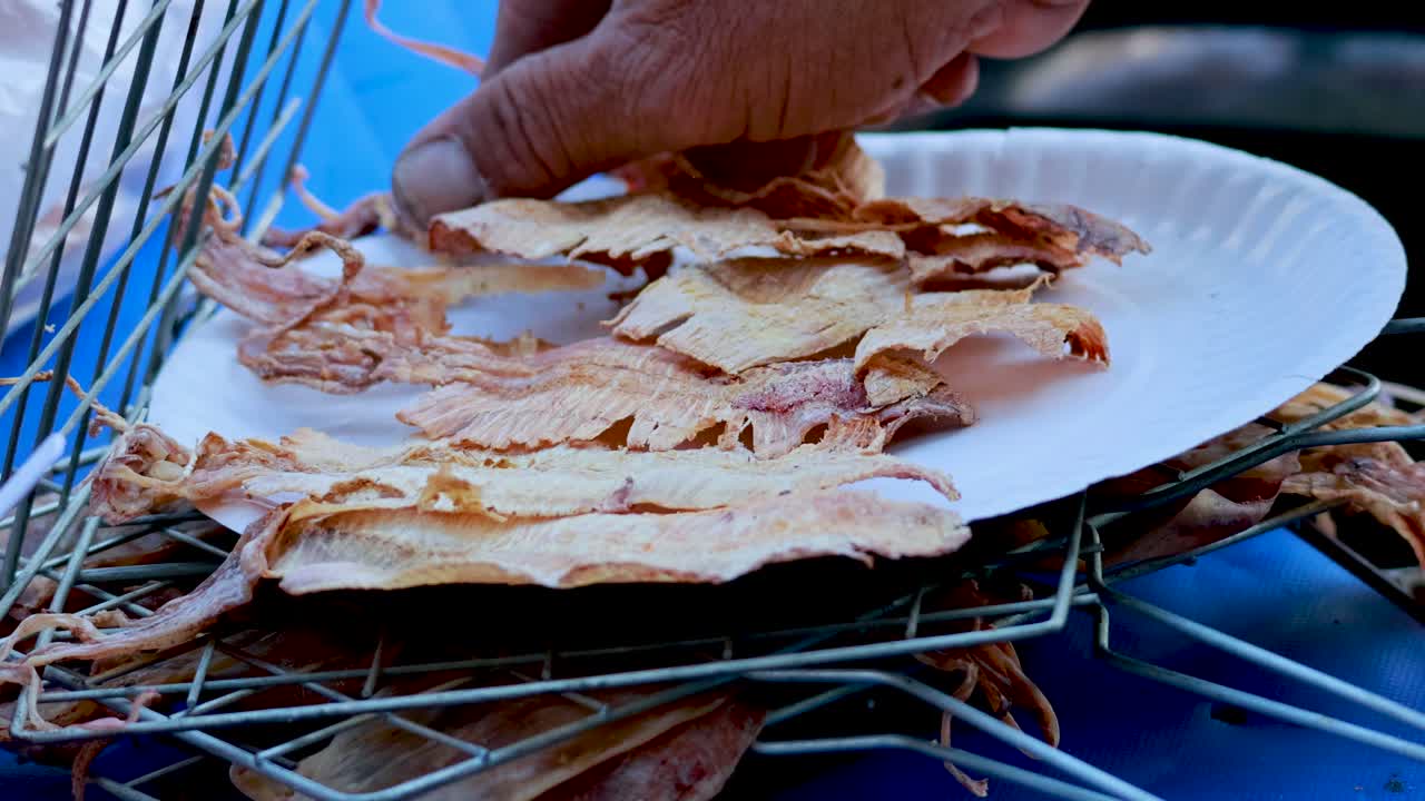 Squid being grilled and served on plate