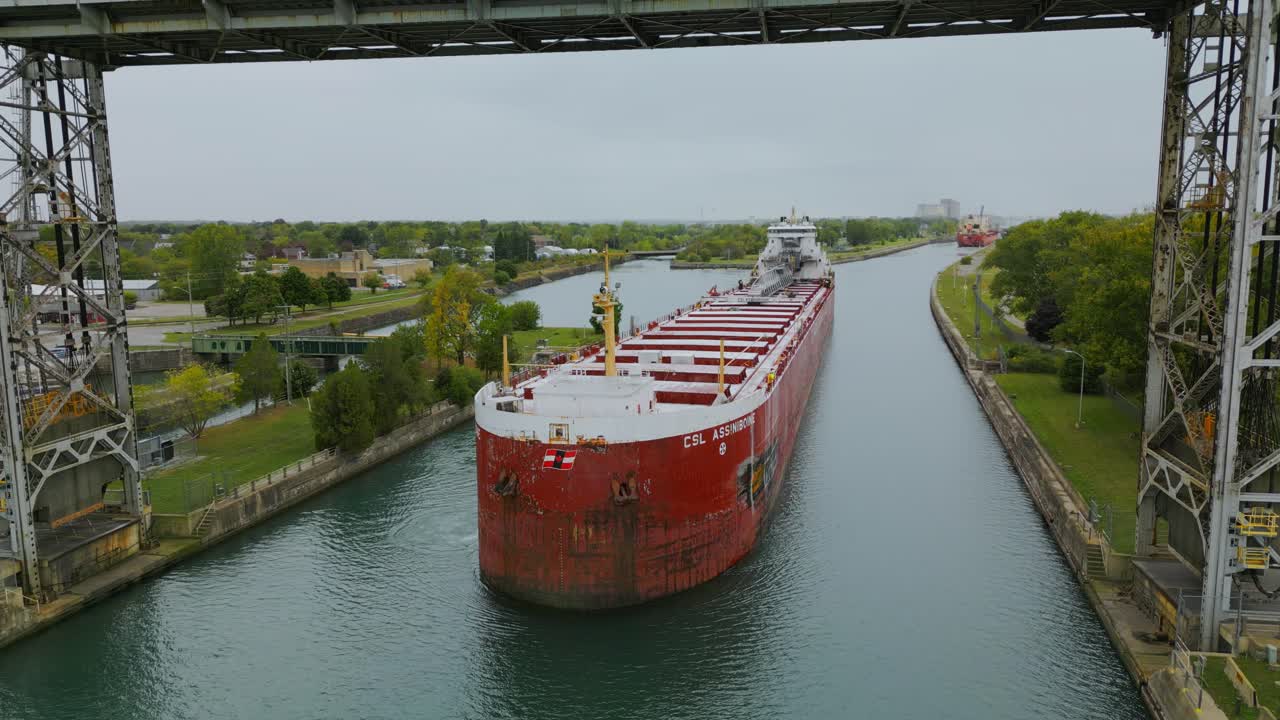 A close up of a boat travelling under the Port Colborne Clarence Street bridge on the Welland Canal