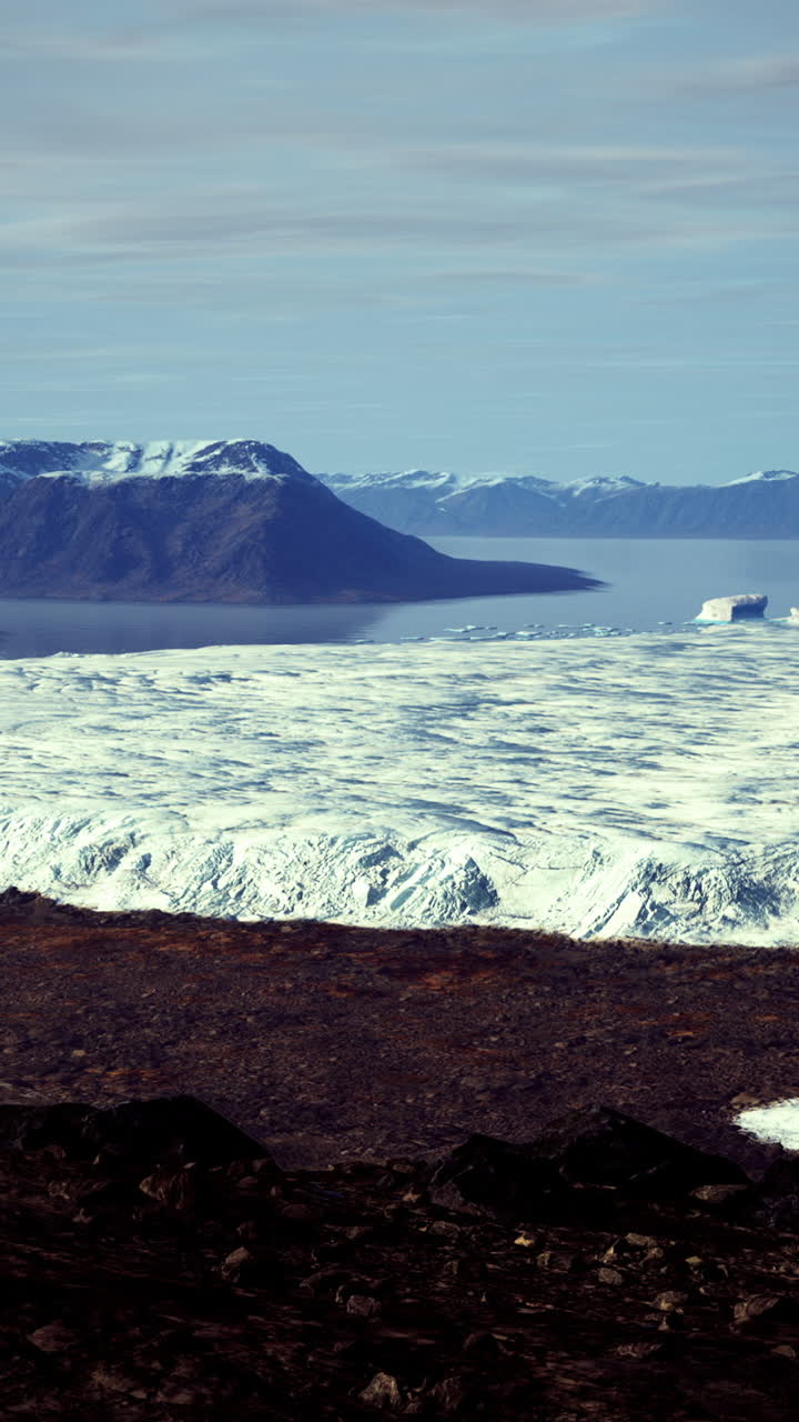 Expansive glacier landscape in a remote mountainous region under clear skies