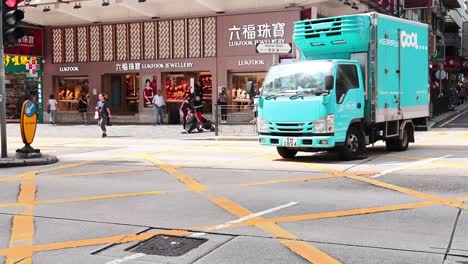 vehicles and pedestrians at a bustling intersection