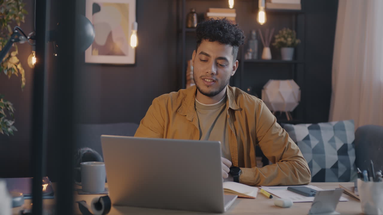 Young Man Working from Home on Laptop