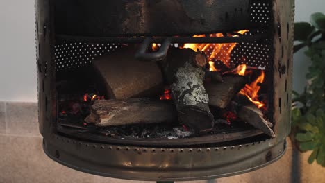 wood logs burning in homade diy metal fire pit