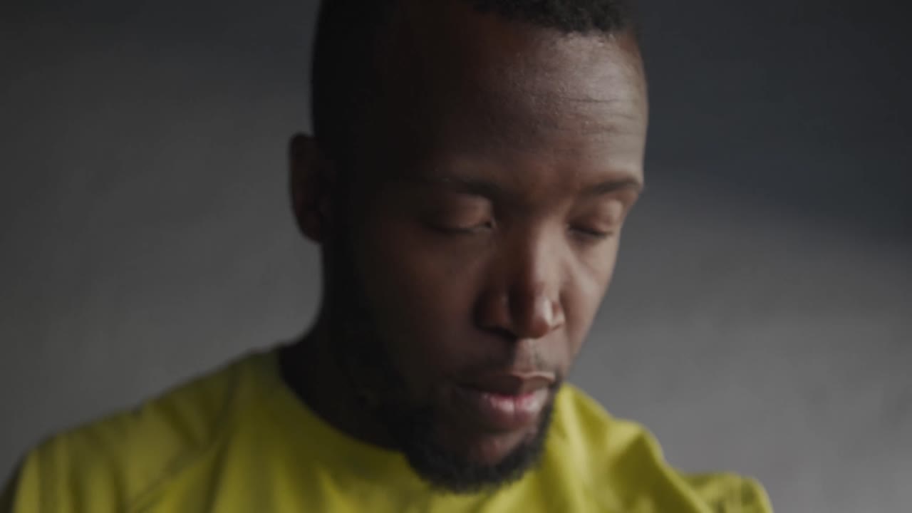 Man training in an urban checking smartwatch