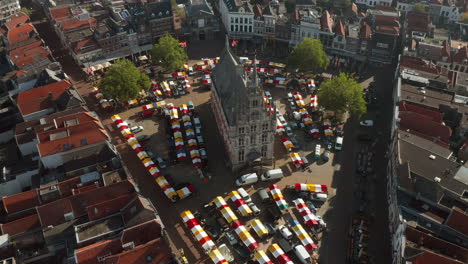 aerial view of gouda's 15th century town hall with market in gouda, netherlands