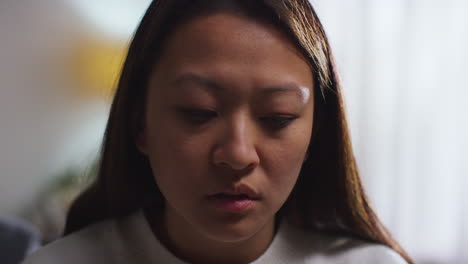 Close-Up-Of-Stressed-Or-Anxious-Woman-Suffering-With-Depression-Anxiety-Or-Loneliness-Sitting-In-Room-At-Home-6