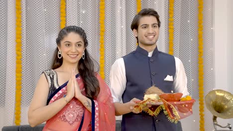 indian couple standing in front of temple