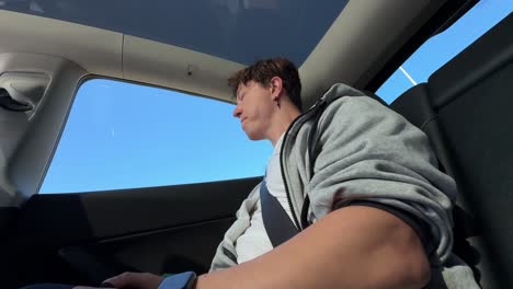 man sitting in the backseat of a car