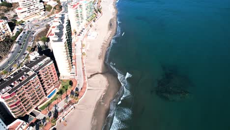 Top-down-view-of-golden-sandy-beach-shoreline,-Fuengirola-Hills-Spain