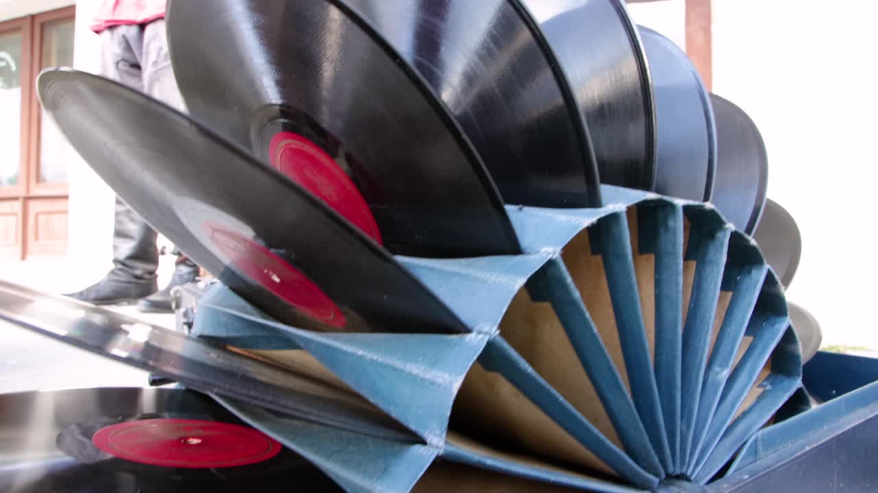 Vinyl records are folded as a set in a cardboard stand.