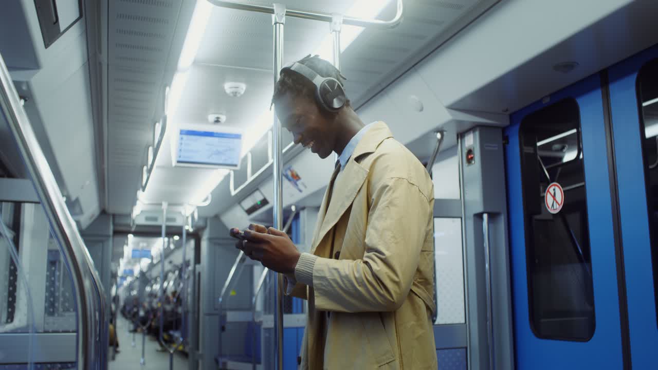 Man using smartphone on subway train