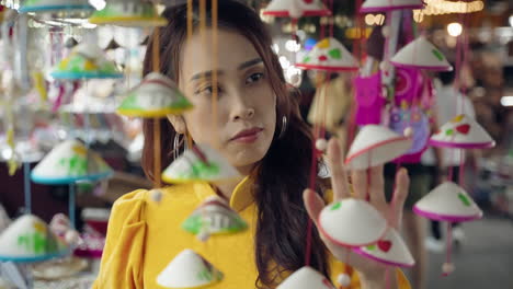 Woman-in-yellow-Ao-Dai-admires-lanterns-in-Hoi-An