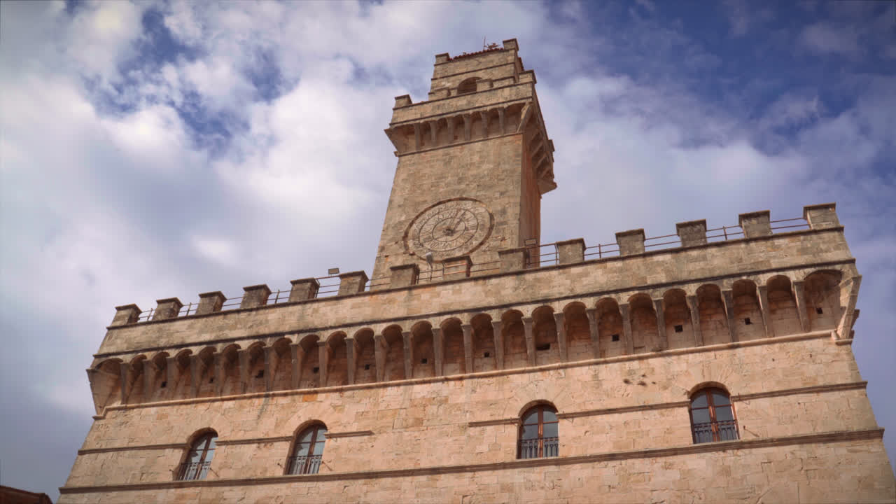 Historic palazzo tower in Montepulciano Tuscany under soft sunlight italian renaissance style