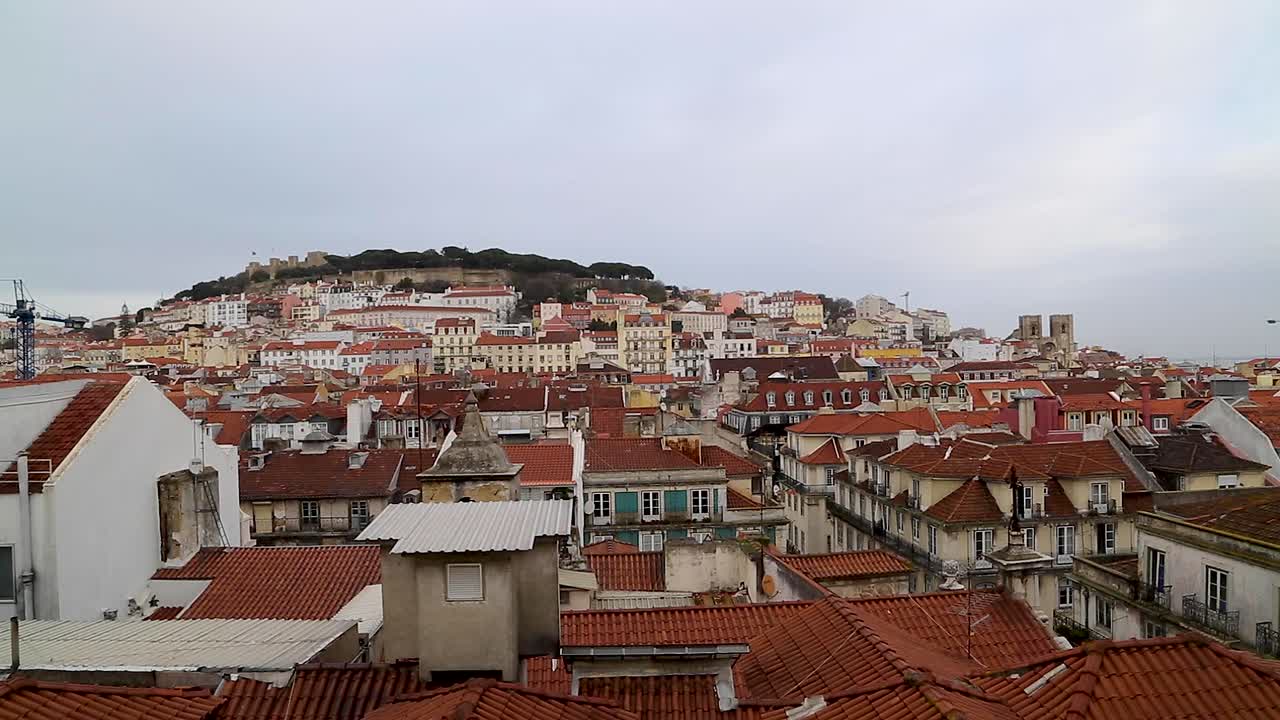 View of medieval castle, Saint George castle, and other buildings by the Tagus river, in the center of Lisbon, Portugal