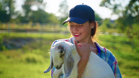 woman holding a baby goat