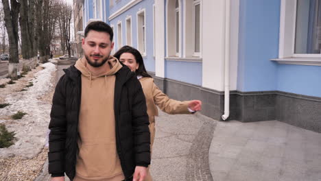 caucasian tourist couple walking through the city.