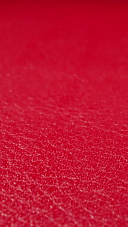 crimson color cow leather material as background upper macro view. sewing supplies for items crafting. design ideas and decorative techniques