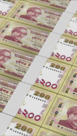 vertical video of 200 bangladeshi taka banknotes printed by a money press