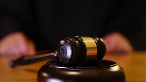 a gavel held high above its block, representing justice and the legal proceedings that occur in a courtroom