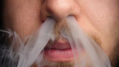 el hombre exhala vapor por la nariz a cámara lenta