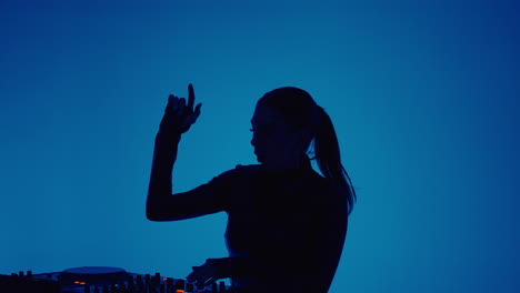 a female dj performing in a nightclub