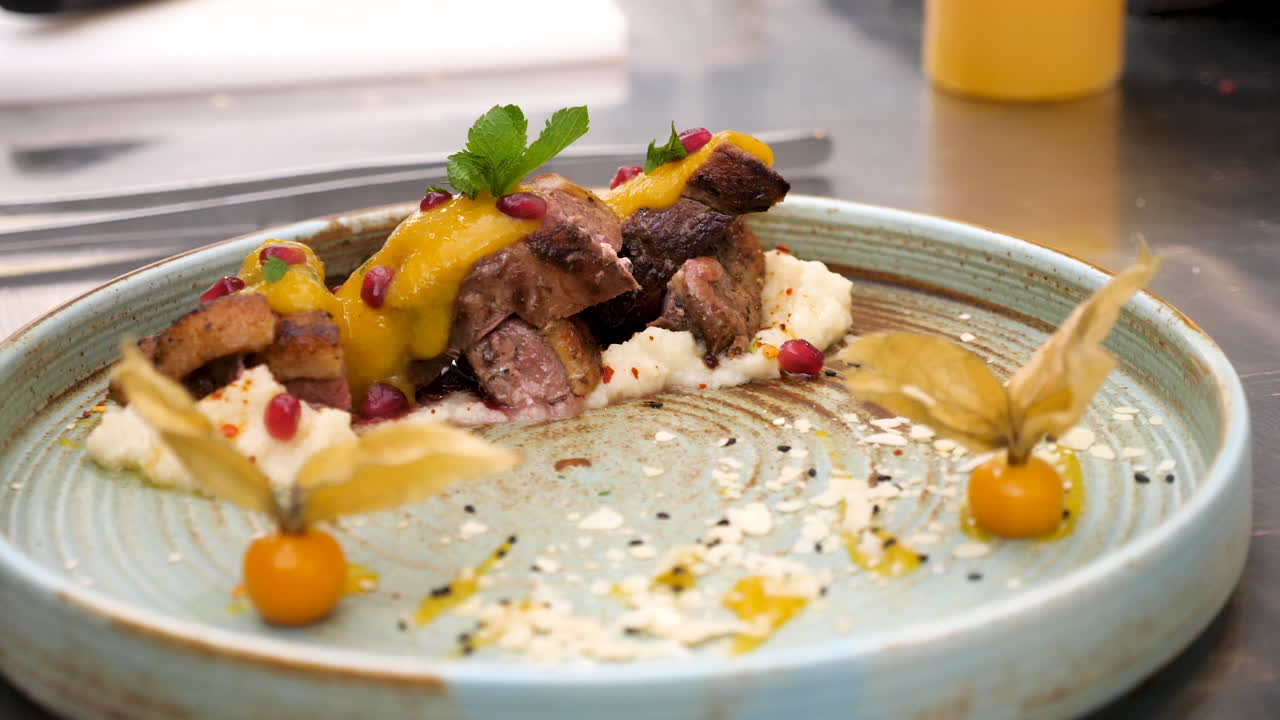 Exquisite plated dish of meat, sauce, and garnishes