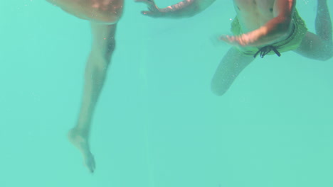 happy couple swimming underwater