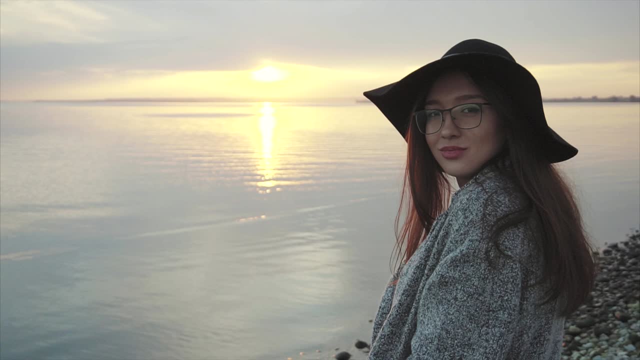 Woman at sunset by the sea