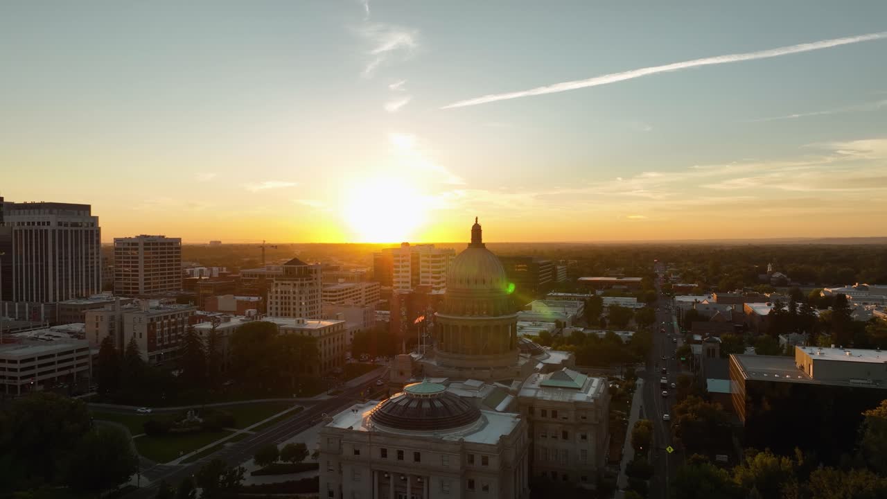 Idaho State Capitol Building and Boise cityscape with golden sunlight and sunflare