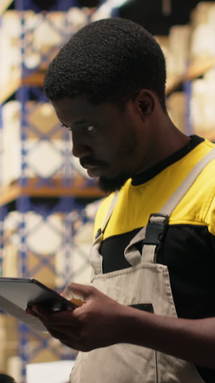 Vertical Video Black staff member using a barcode scanner to process shipping labels