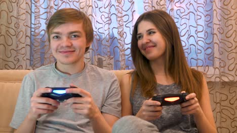 couple playing video games at home