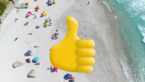 Digital-composition-of-thumbs-up-icon-against-aerial-view-of-the-beach