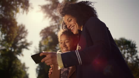 Happy-mother-daughter-selfie-posing-in-golden-sunlight.-Joyful-time-together.