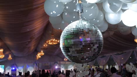 slow motion video of a disco light, overhead at a wedding party