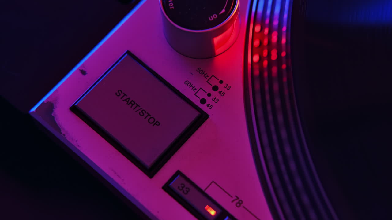 A working record player. Start and stop button. Neon red and blue illumination around