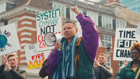 group of protestors with placards and megaphone on demonstration march against climate change