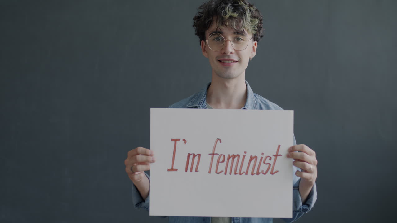 Young Person Holding Sign Expressing Support for Feminism