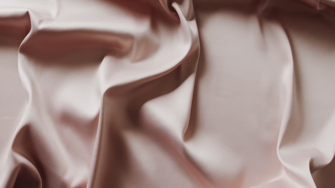 Close up of white shiny silk cloth in slow motion