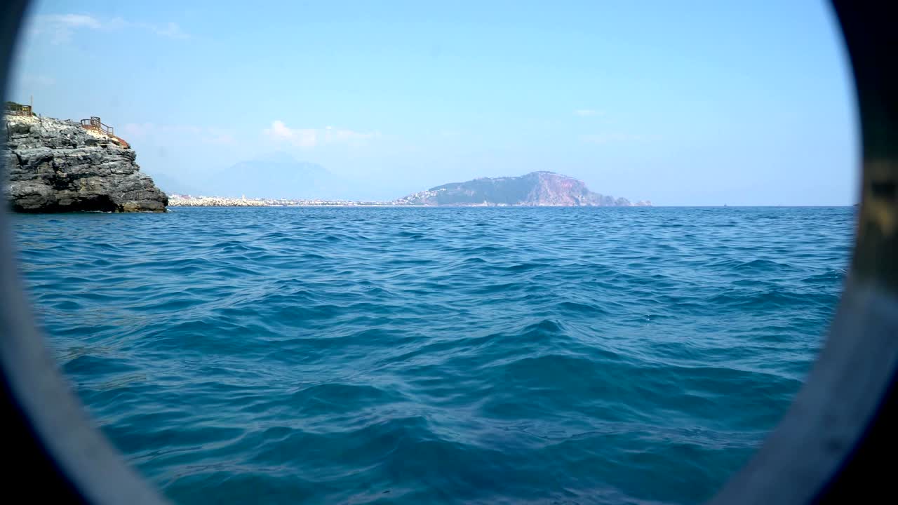 Distant view of the island from the porthole of the ship