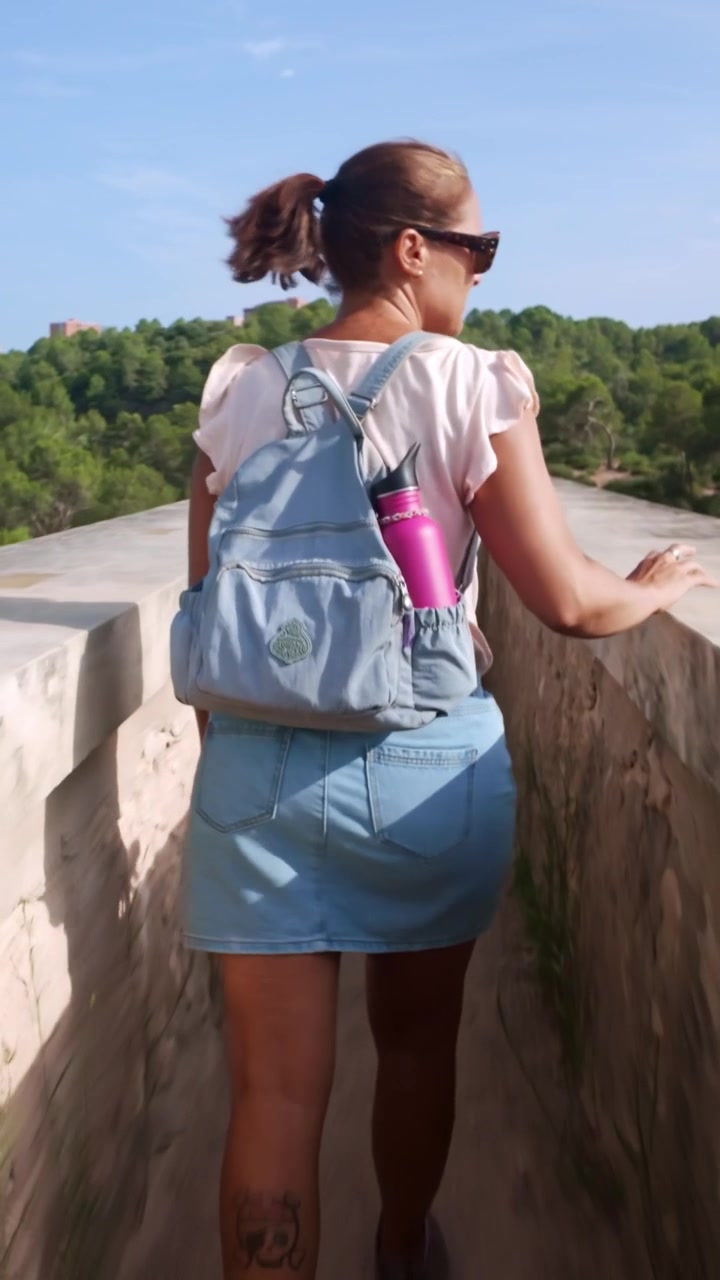 Woman walking along ancient Roman aqueduct in Tarragona