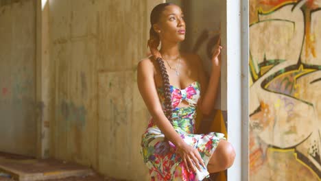 360 pan of a young girl looking up at the sun rays with grafitti art in the background