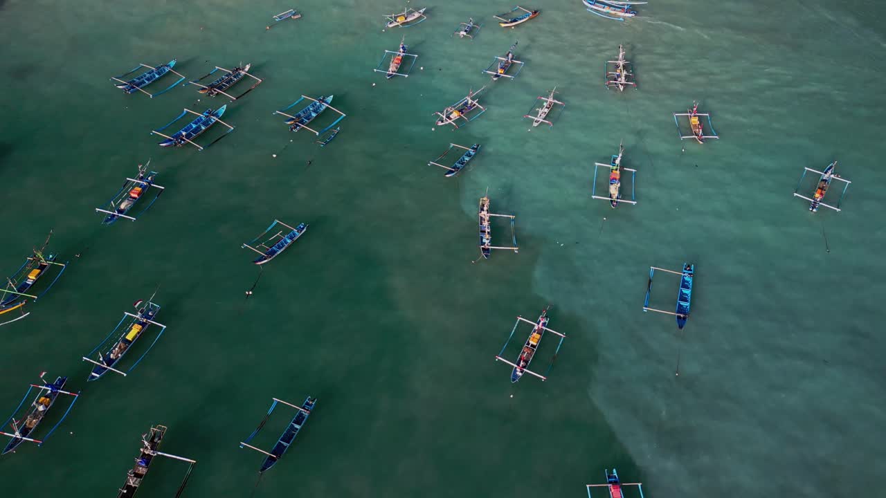 Colorful traditional canoes in Bali harbor anchored together in turquoise waters, representing Indonesian fishing traditions, ocean lifestyle, and the island’s coastal cultural heritage