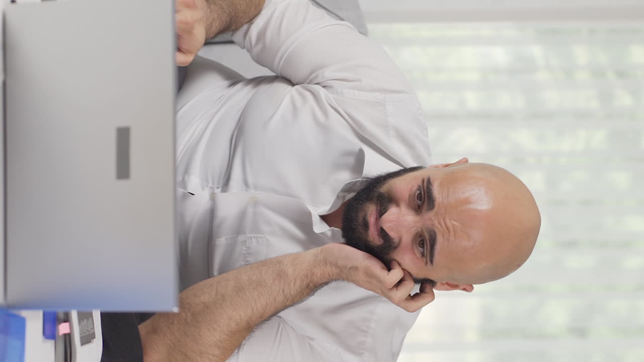 Vertical video of Home office worker man feels physical good.