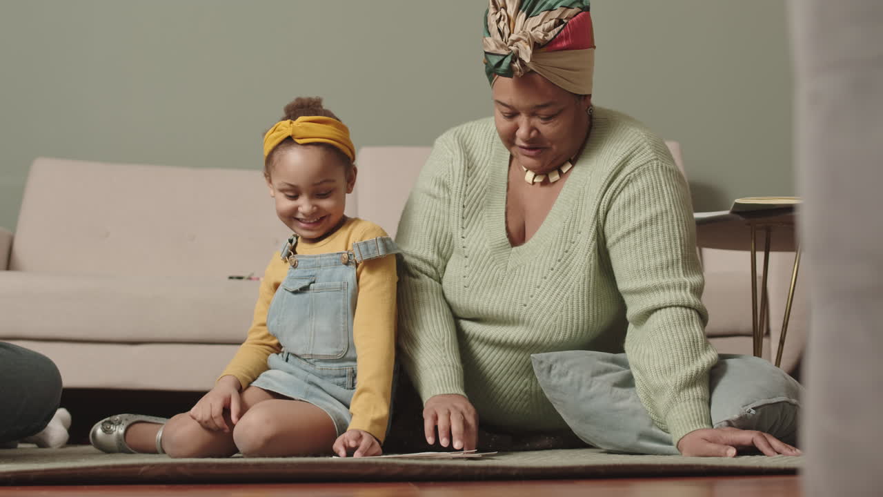 Aged African Woman Helping Her Granddaughter Learning Alphabet