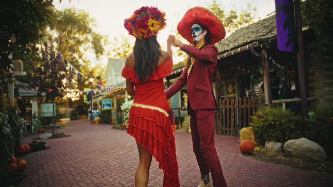 Couple Dancing in Dia de los Muertos Costumes