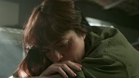 pensive woman, brooding atmosphere of lonely latina in laundry room, close up, sad moment