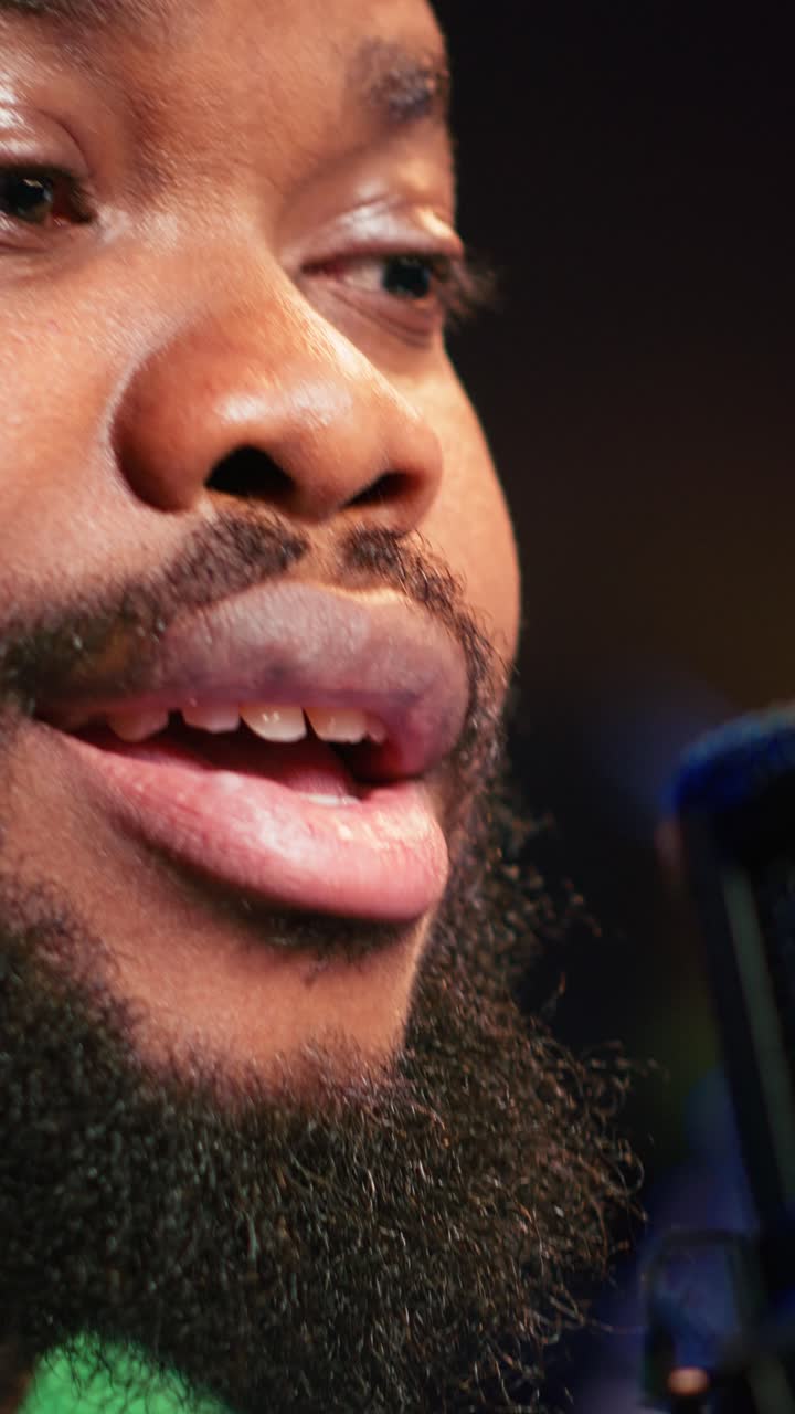 Close-up of African American Man Speaking into Studio Microphone