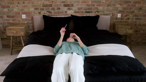 happy woman laying on the bed