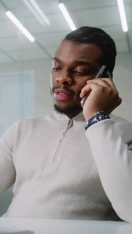 man talking on phone in office